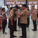 Bupati Tabalong, Anang Syakhfiani mengalungkan kain sasirangan kepada perwakilan peserta Rainas XII 2023 kontingen Tabalong (Kalimantanlive.com/ A Hidayat)